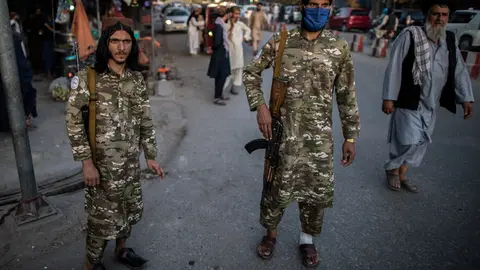 Two Taliban police officers patrol a street in Kunduz, Afghanistan, on Friday. A senior Taliban official has claimed that the Islamic State terrorist group does not pose a threat in Afghanistan and the Taliban have the capacity to restrain them. Photo: Oliver Weiken/dpa