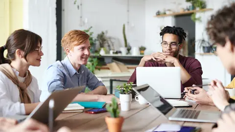 Team of workers of a company, in their office. Photo: Pexels.
