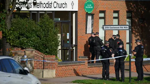 15 October 2021, United Kingdom, Leigh-On-Sea: Armed police officers stand at the scene near the Belfairs Methodist Church in Eastwood Road North, where Conservative lawmaker Sir David Amess has died after he was stabbed several times at a constituency surgery. Photo: Yui Mok/PA Wire/dpa