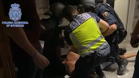 Police officers at the time of arrest. Image: screenshot from Police video.