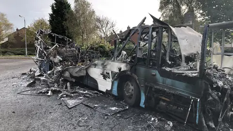A general view of a destroyed bus on Abbott Drive where assailants hijacked and set the vehicle alight in an attack politicians have linked to loyalist opposition to Brexit's Northern Ireland Protocol. Photo: David Young/PA Wire/dpa.
