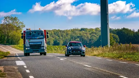 A car overtaking a truck on a conventional road. Photo: Pixabay.