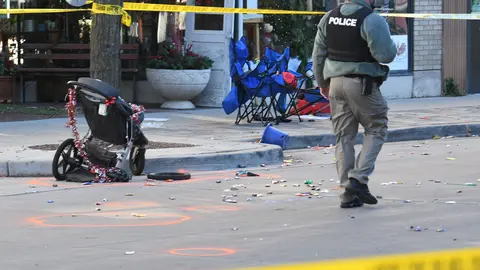 FILED - A police officer investigates the scene in downtown Waukesha after a SUV vehicle plowed into the Waukesha Christmas parade in Wisconsin. Several people were dead and dozens injured. Photo: Mark Hertzberg/ZUMA Press Wire/dpa.