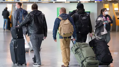 Passengers move through Frankfurt Airport on Friday. The European Commission says it wants to limit air travel from southern African into the bloc due to fears about a new Covid-19 variant discovered there, following similar moves announced by Britain and Israel. Photo: Boris Roessler/dpa.