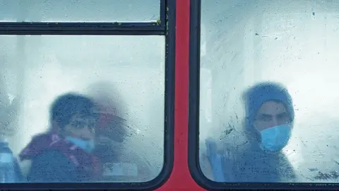 25 November 2021, United Kingdom, Dover: A group of people thought to be migrants sit on a bus after arriving in Dover, Kent, following a small boat incident in the Channel. 27 migrants died yesterday after their boat capsized in the English Channel, the French Interior Ministry has said. Photo: Gareth Fuller/PA Wire/dpa.