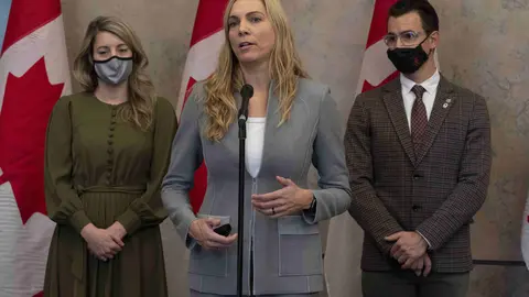 08 December 2021, Canada, Ottawa: Canada's Foreign Affairs Minister Melanie Joly (L) and former Olympic medalist and Liberal MP for Milton Adam van Koeverden listen to Canada's Minister of Sport Pascale St-Onge as she talks about a diplomatic boycott of the Winter Games in China. Photo: Adrian Wyld/The Canadian Press via ZUMA/dpa.