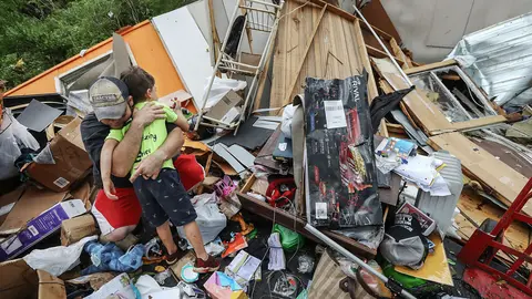 FILED - A man embraces his son among the rubble of their house after the family survived a deadly tornado that killed at least seven in Murray County, Georgia, in this file shot from December 11, 2020. Photo: Curtis Compton/TNS via ZUMA Wire/dpa.
