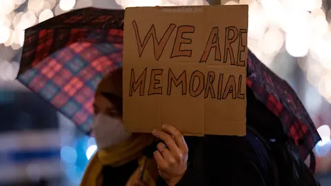 13 December 2021, Berlin: A participant in the rally against the threatened dissolution of the Russian human rights organization Memorial holds up a sign with the inscription "Wie are Memorial" in front of the Russian embassy. The organization, which was founded in the late 1980s, works, among other things, for political prisoners and for the reappraisal of Stalinist and Nazi crimes in the former Soviet Union. Photo: Monika Skolimowska/dpa-Zentralbild/dpa.