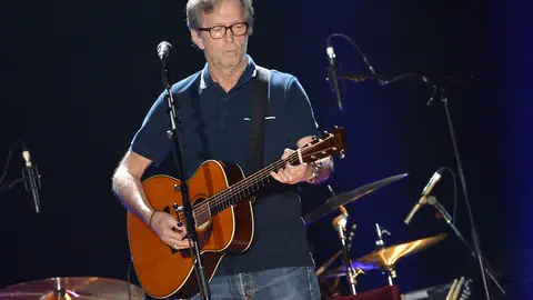 FILED - 30 May 2013, Berlin: British singer Eric Clapton performs on the stage of o2 World in Berlin. Clapton has waived his claims against a German woman after winning a case about bootleg CDs, according to a statement on his homepage. Photo: Britta Pedersen/dpa-Zentralbild/dpa.