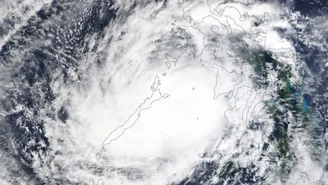 HANDOUT - 17 December 2021, ---: An image aquired via the Moderate Resolution Imaging Spectroradiometer (MODIS) on NASA's Terra satellite shows the typhoon Rai sweeping through the western side of the Philippines. Emergency teams in the Philippines on Saturday rushed aid to areas battered by the strongest typhoon to hit the country this year, which killed up to 24 people and displaced more than 330,000. Photo: -/Nasa Earth via ZUMA Press Wire Service/dpa - ATTENTION: editorial use only and only if the credit mentioned above is referenced in full.