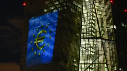30 December 2021, Hessen, Frankfurt/Main: The European Currency "Euro" symbol is projected onto the south facade of the European Central Bank's (ECB) headquarters in Frankfurt's East End. On New Year's Eve 20 years ago, the single European currency, the euro, was introduced in twelve EU countries. Photo: Arne Dedert/dpa.