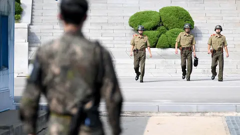 FILED - 26 July 2018, South Korea, Panmunjeom: A border guard standing in the demilitarized zone (DMZ) between North and South Korea and looking towards the North. Photo: Britta Pedersen/dpa-Zentralbild/dpa.