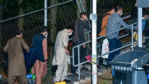 FILED - 20 August 2021, Brandenburg, Doberlug-Kirchhain: Local forces from Afghanistan walk to their accommodation on the grounds of the DRK Refugee Aid at the Initial Reception Centre in the early morning. About 71,400 applications for asylum were lodged in the European Union and associated countries in November, up by 9 per cent from October and the second-highest level since the refugee crisis of 2016, an EU authority said on Friday. Photo: Patrick Pleul/dpa-Zentralbild/dpa.