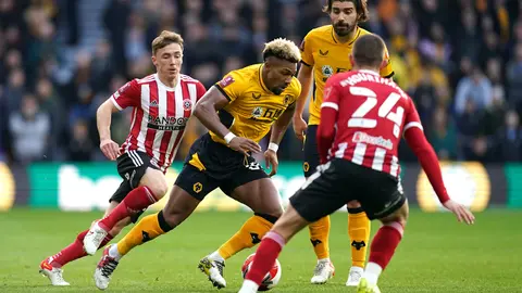 09 January 2022, United Kingdom, Wolverhampton: Wolverhampton Wanderers' Adama Traore (C) battles for the ball with Sheffield United's Conor Hourihane (R) during the English FA Cup third round soccer match between Wolverhampton Wanderers and Sheffield United at Molineux Stadium. Photo: Nick Potts/PA Wire/dpa.
