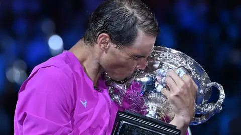 31 January 2022, Australia, Melbourne: Spanish tennis player Rafael Nadal kisses the Norman Brookes Challenge Cup after winning the men's singles final tennis match of the Australian Open against Russia's Daniil Medvedev. Photo: Dean Lewins/AAP/dpa.