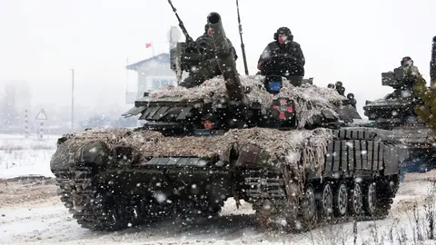 10 February 2022, Ukraine, Kharkiv Region: Soldiers of the Ivan Sirko 92nd Mechanised Brigade of the Ukrainian Armed Forces ride a tank during a drill, as tensions remain high over the build-up of Russian forces near the border with Ukraine. Photo: -/Ukrinform/dpa.