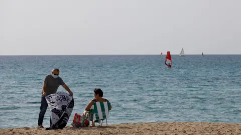12 February 2022, Spain, Arenal: People sunbath on the beach of Arenal in Mallorca. In view of falling Corona numbers, the outdoor mask requirement ended in Spain on Feb. 10. Photo: Clara Margais/dpa.