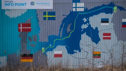 22 February 2022, Mecklenburg-Western Pomerania, Lubmin: A sign reading "Nord Stream 2 Committed. Reliable. Safe." hangs above a painted map on an information container for the Nord Stream 2 gas pipeline at the Lubmin industrial park. The German government is halting the approval process for the Nord Stream 2 gas pipeline in light of developments in the Ukraine conflict, government sources told dpa. Photo: Stefan Sauer/dpa.