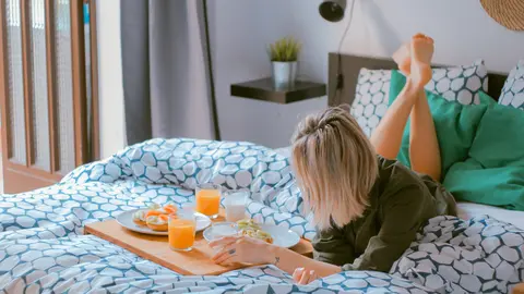A traveler has breakfast in her hotel room in Barcelona. Photo: Unsplash/File photo.