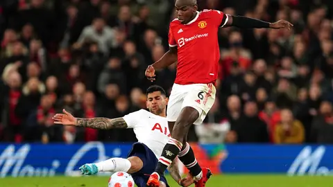 12 March 2022, United Kingdom, Manchester: Tottenham Hotspur's Cristian Romero (L) and Manchester United's Paul Pogba battle for the ball during the English Premier League soccer match between Manchester United and Tottenham Hotspur at Old Trafford. Photo: Martin Rickett/PA Wire/dpa.