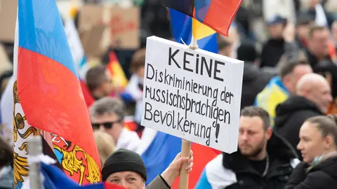 10 April 2022, Hessen, Frankfurt/Main: People hold a placard during a pro-Russian demonstration. Photo: Boris Roessler/dpa.