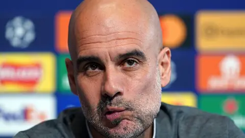25 April 2022, United Kingdom, Manchester: Manchester City manager Pep Guardiola reacts during a press conference at the City Football Academy ahead of Tuesday's UEFA Champions League semi-final first leg soccer match against Real Madrid. Photo: Martin Rickett/PA Wire/dpa.