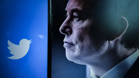 25 April 2022, France, Clermont-Ferrand: A view of the logo of the American social networking company Twitter on a smartphone screen beside a Portrait of the entrepreneur Elon Musk. Shares of Twitter, Inc are rising almost 5% in pre-market on Monday after reports that the microblogging site's board is set to accept an offer from Tesla founder Elon Musk as early as Monday. Photo: Adrien Fillon/ZUMA Press Wire/dpa.