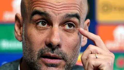 25 April 2022, United Kingdom, Manchester: Manchester City manager Pep Guardiola speaks during a press conference at the City Football Academy ahead of Tuesday's UEFA Champions League semi-final first leg soccer match against Real Madrid. Photo: Martin Rickett/PA Wire/dpa.