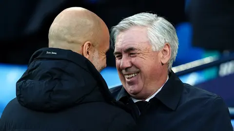 26 April 2022, United Kingdom, Manchester: Real Madrid manager Carlo Ancelotti and Manchester City manager Pep Guardiola greet each other before the start of the UEFA Champions League Semi Final, First Leg, soccer match between Manchester City and Real Madrid at the Etihad Stadium. Photo: Martin Rickett/PA Wire/dpa.