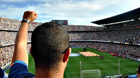 A Barcelona fan cheers from the Camp Nou stands. Photo: Pixabay.