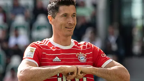 FILED - 14 May 2022, Lower Saxony, Wolfsburg: Munich's Robert Lewandowski celebrates scoring his side's second goal during the German Bundesliga soccer match between VfL Wolfsburg and Bayern Munich at Volkswagen Arena. Barcelona have made a first written transfer bid of €32 million ($33.8 million) for Bayern Munich striker Robert Lewandowski, according to a report on Sunday. Photo: Swen Pförtner/dpa.
