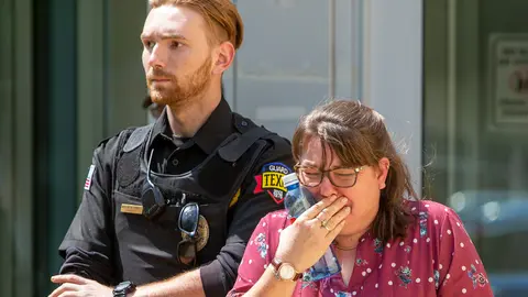 24 May 2022, US, Uvalde: A woman burst into tears as she leaves the Uvalde Civic Center. Fourteen students and one teacher were killed in a shooting in an elementary school in the small town of Uvalde Governor Greg Abbott has said in a press conference. Photo: San Antonio Express-News/SanAntonio Express-News via ZUMA/dpa.