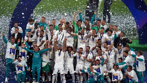 28 May 2022, France, Paris: Real Madrid players celebrate with the UEFA Champions League trophy after the UEFA Champions League final soccer match between Liverpool FC and Real Madrid CF at the Stade de France. Photo: Peter Byrne/PA Wire/dpa.