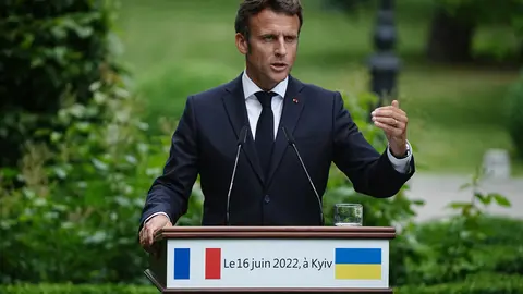 FILED - 16 June 2022, Ukraine, Kiev: French President Emmanuel Macron speaks during a joint press conference with Ukrainian President Volodymyr Zelensky, German Chancellor Olaf Scholz, Italian Prime Minister Mario Draghi and Romanian President Klaus Iohannis after their meeting. A second and final round of parliamentary elections began in France on Sunday, with President Emmanuel Macron aiming to resecure an absolute majority for members of his centrist La Republique en Marche (The Republic on the Move, LREM) party. Photo: Kay Nietfeld/dpa.