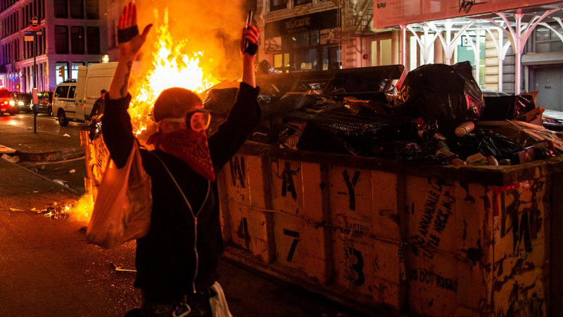 A protester walks with his hands up while looting after marching against the death in Minneapolis police custody of George Floyd, in the Manhattan borough of New York City, U.S., June 1, 2020. REUTERS/Eduardo Munoz