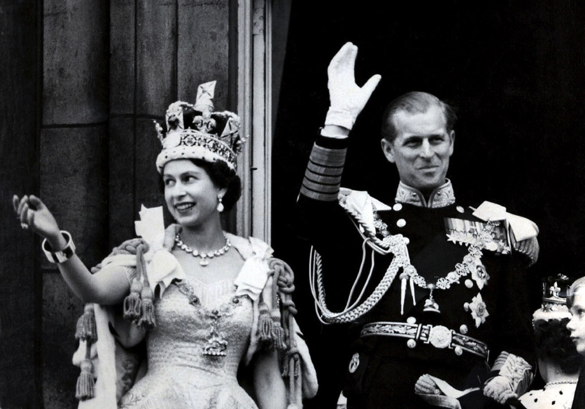 FILED - 02 June 1953, United Kingdom, London: Queen Elizabeth II (L) and her husband Prince Philip, the Duke of Edinburgh, wave from the balcony to the on looking crowds around the gates of Buckingham Palace after her Coronation. Prince Philip died on Friday at the age of 99. Photo: -/PA Wire/dpa