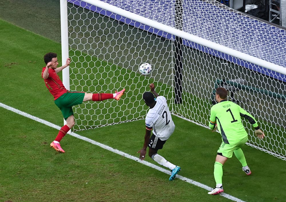 19 June 2021, Bavaria, Munich: Portugal's Diogo Jota (L) scores his side's second goal during the UEFA EURO 2020 Group F soccer match between Portugal and Germany at the Allianz Arena. Photo: Federico Gambarini/dpa