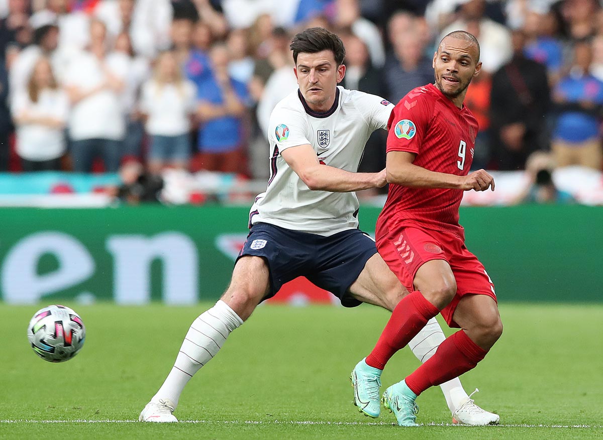 07 July 2021, United Kingdom, London: England's Harry Maguire (L) and Denmark's Martin Braithwaite battle for the ball during the UEFA Euro 2020 semi final soccer match between England and Denmark at Wembley Stadium. Photo: Nick Potts/PA Wire/dpa