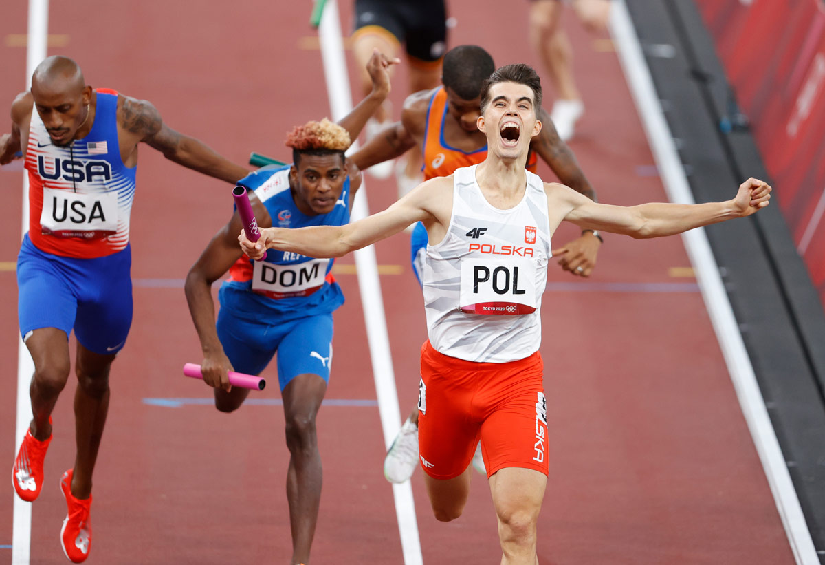 31 July 2021, Japan, Tokyo: Poland's Kajetan Duszynski celebrates as he crosses the finish line to claim the gold medal for his team in the 4 x 400m Relay Mixed Final of the athletics competition at the Olympic Stadium, during Tokyo 2020 Olympic Games. Photo: Oliver Weiken/dpa