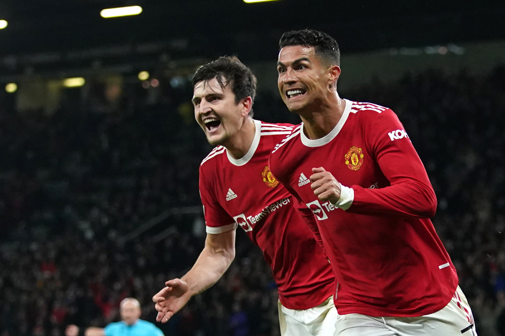 20 October 2021, United Kingdom, Manchester: Manchester United's Cristiano Ronaldo (R) celebrates scoring his side's third goal with Harry Maguire during the UEFA Champions League Group F soccer match between Manchester United and Atalanta at Old Trafford. Photo: Martin Rickett/PA Wire/dpa