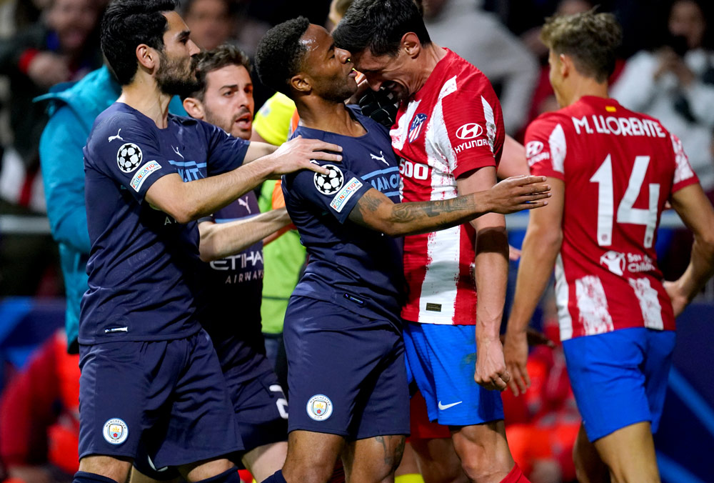 13 April 2022, Spain, Madrid: Atletico Madrid's Stefan Savic clashes with Manchester City's Raheem Sterling during the UEFA Champions League Quarter-final second leg soccer match between Atletico Madrid and Manchester City FC at Wanda Metropolitano stadium. Photo: Nick Potts/PA Wire/dpa.